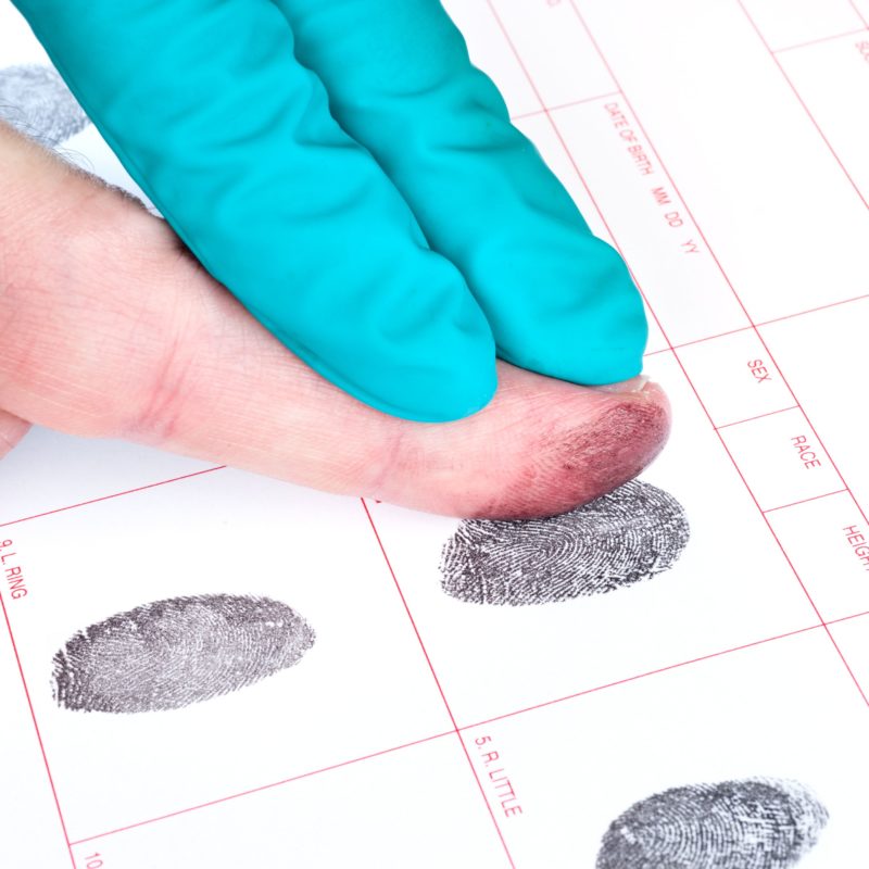 Man being fingerprinted